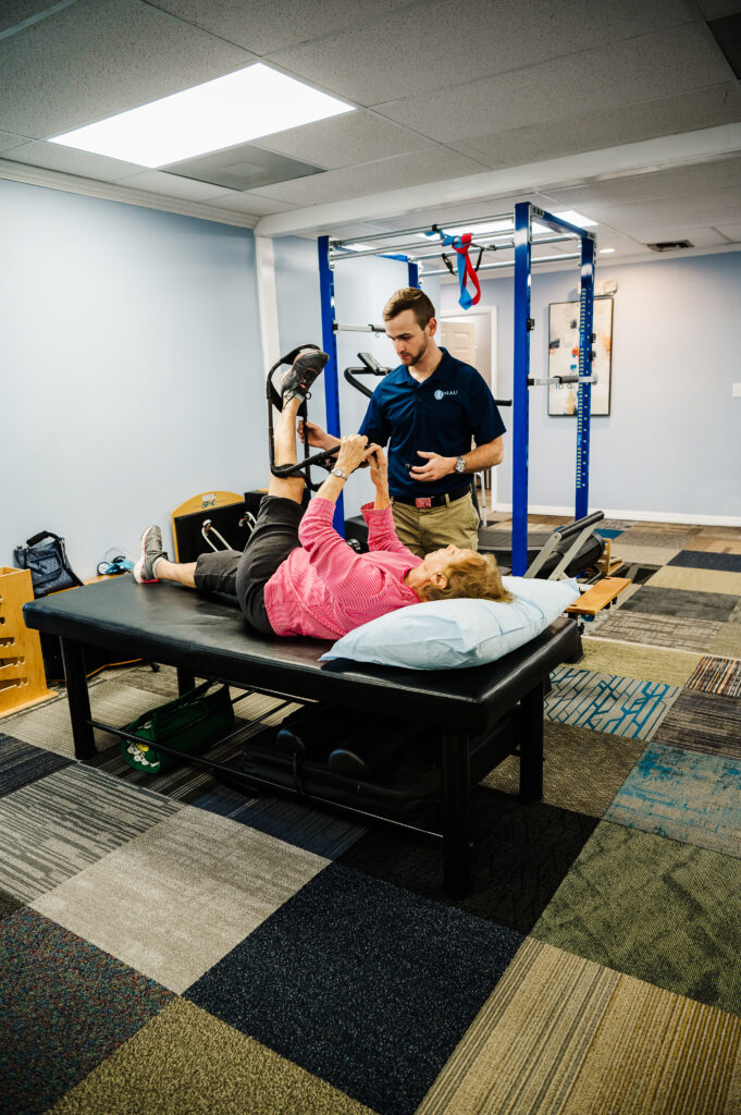 Chad with a patient in the NAU PT and Wellness office